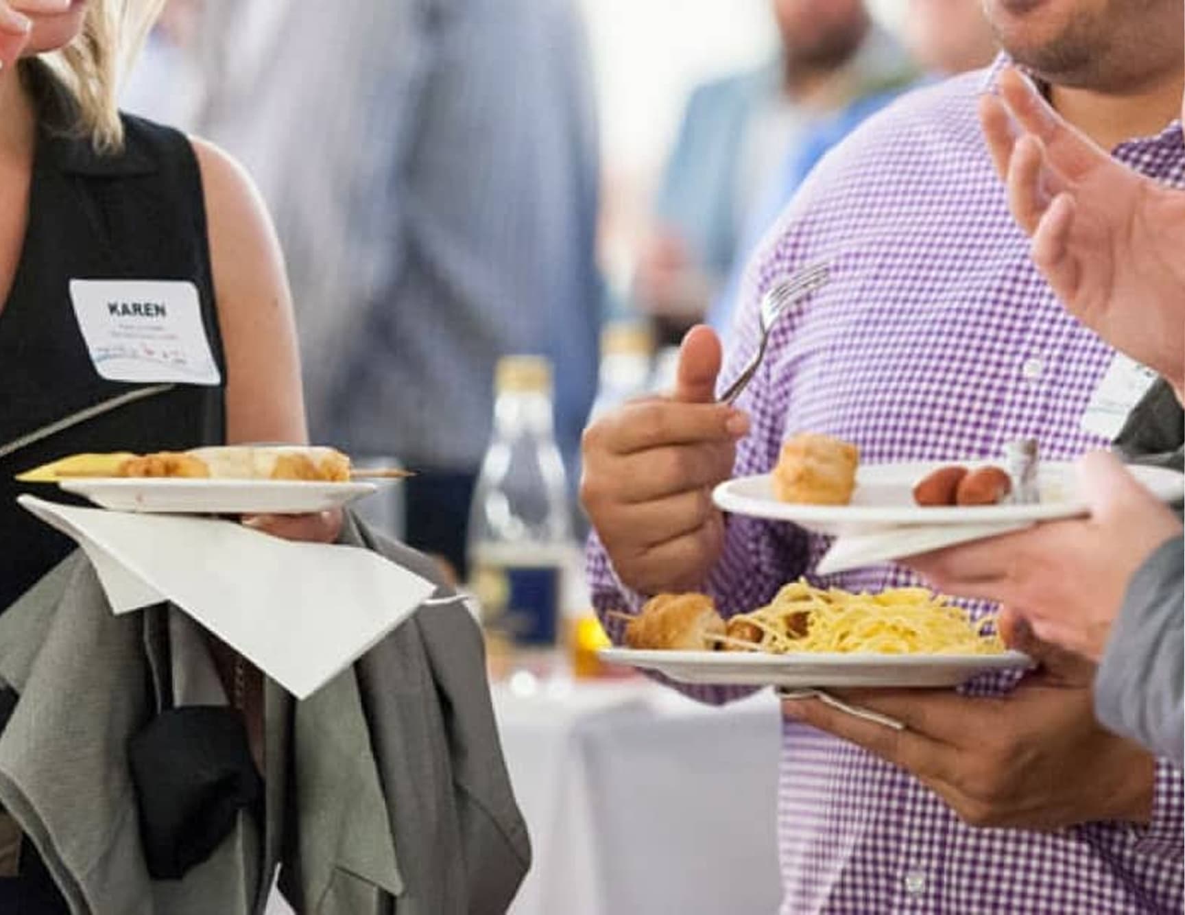 People enjoying event with plates of delicious local food